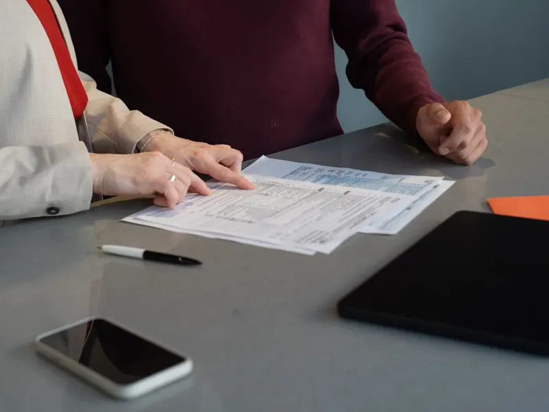 Two people reviewing a welcome document together across a desk